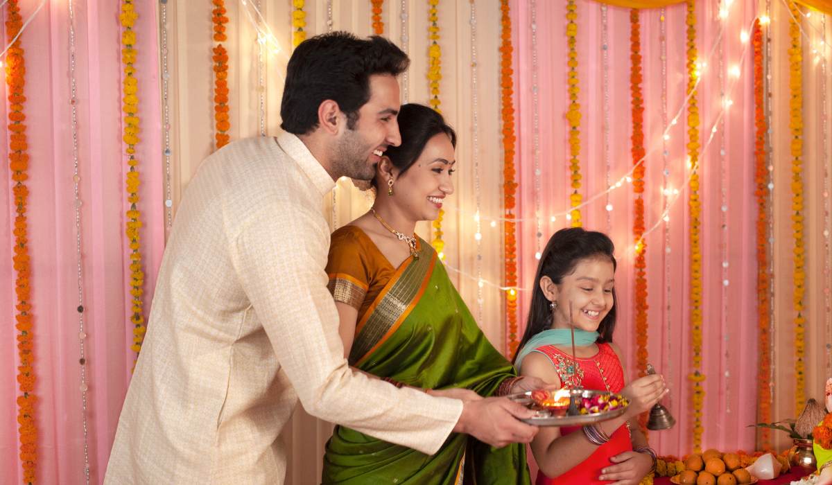 Website banner featuring families in traditional Indian attire celebrating Diwali